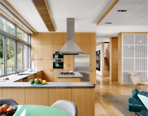 In an Austin, Texas, residence, New York architect Ali Tayar specified white oak for the floors, moldings, ceiling-light diffusers, and kitchen cabinetry, which was custom made by Arete Kitchens. Photograph by Casey Dunn