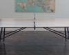 The Clip Leg Ping Pong Table from District Mills has a reclaimed walnut top on black steel and brass legs.
