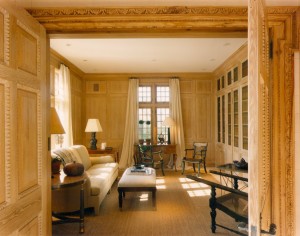 An East Hampton library/media room with cerused oak paneling and cabinetry by Stedila Design.