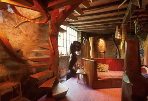 The living room of the Wharton Esherick house, with the famous hand-carved red-oak spiral staircase from 1930, and many examples of Esherick’s furniture and sculpture, including Oblivion, which depicts two entwined lovers carved from the trunk of a walnut tree. Photo by G. Widman for GPTMC.