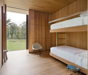 White oak slats allow for natural ventilation in the bunk alcove, whose built-in furniture was made by Simrel Achenbach of Descience Lab, as was all the custom millwork in the house.