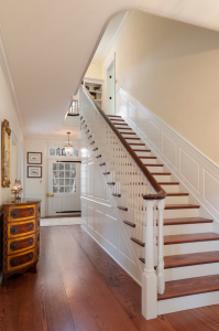 A traditional staircase of red oak and painted poplar in a Gladwyne, PA, house by E.B. Mahoney Builders, Inc., and Archer & Buchanan Architecture, Ltd. Photograph by Tom Crane.