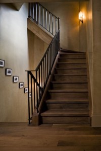 A cerused-white-oak staircase with a blackened-steel and patinated-bronze balustrade in a Westchester County, NY, residence by Glenn Gissler Design. Photograph by Gross & Daley.