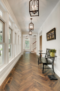 American black walnut herringbone floor in the reception hall of a new house in Minneapolis by Divine Custom Homes. Photograph by Spacecrafting.com