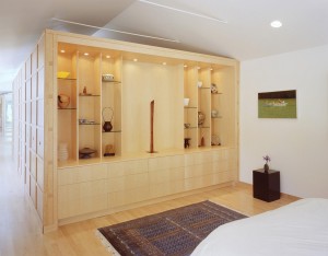 A maple box housing built-in display and storage cabinetry, two walk-in closets, and a traditional Japanese bathroom separates the bedroom from the home gym in this Sunnyvale, California, house by John Lum Architecture. Photograph by Sharon Risedorph