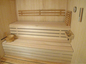 This indoor home sauna of white aspen with matching basswood benches was made from a customized kit by Superior Sauna & Steam, a Wisconsin-based manufacturer.