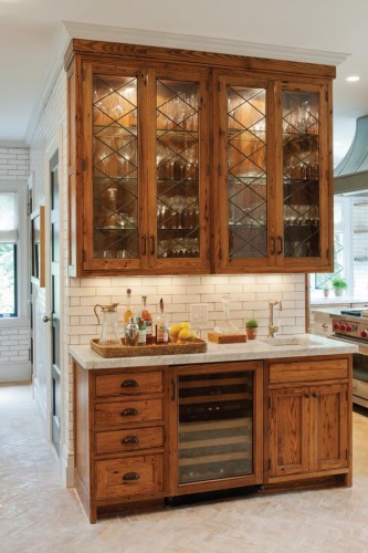Crown Point Cabinetry installed a wet bar and drinks cabinet made of reclaimed American chestnut in the renovated kitchen of a 1920s Dutch colonial house in Connecticut. Photograph by Crown Point Cabinetry
