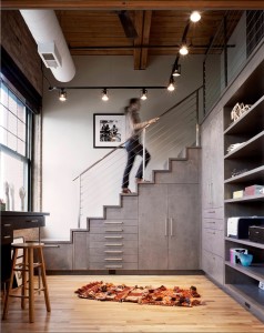 Architect Elissa Scrafano stacked birch drawers, cupboards, and closets to create a staircase in a renovated Chicago loft. Photography by Catherine Tighe 