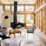 In the living room of an Austin, Texas, house designed by Webber + Studio, window walls are framed in white oak stained a warm honey color. Photograph by Casey Dunn 