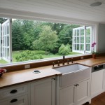 Archia Home’s renovation of the kitchen in a 19th-century farmhouse in Dover, Massachusetts, included installing a 16-foot long wood-framed folding window above the sink counter. 