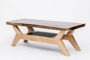 The Danish Modern coffee table has a black walnut top and maple base.